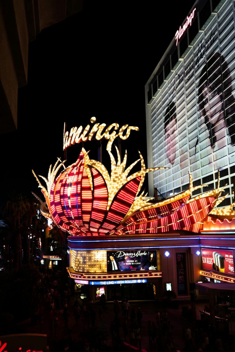 Bright neon lights of the Flamingo Hotel casino at night in Las Vegas.
